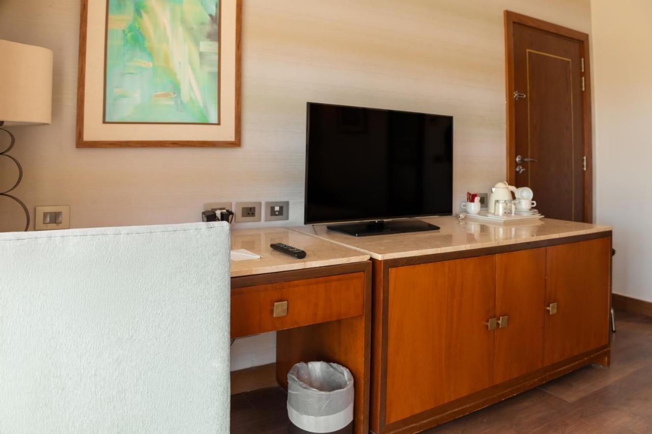 Отель Sharm Dreams Vacation Club - Aqua Park Экстерьер фото A television in a hotel room